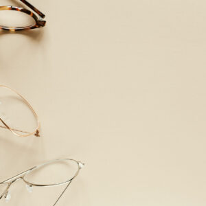 Three different styles of eyewear on a desk.